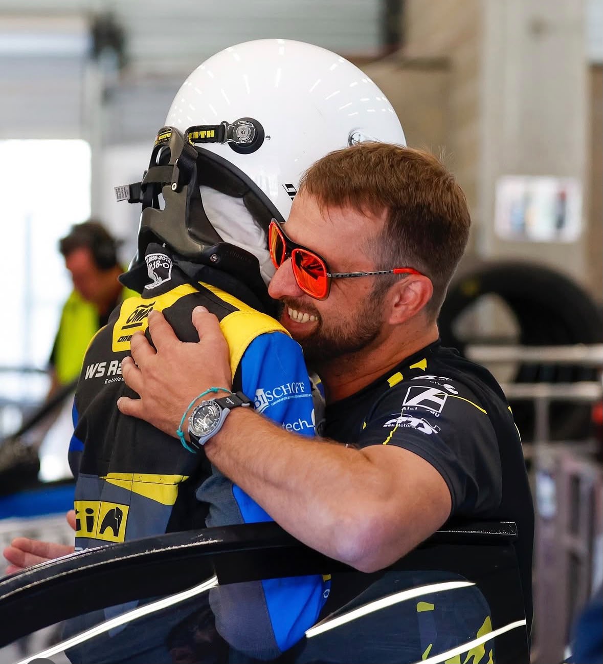 Matthias Möller celebrating with a racing driver at the racetrack
